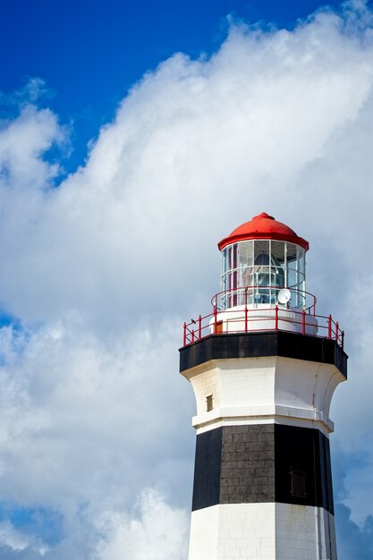 Vertical low angle shot of a lighthouse under the beautiful cloud in the sky