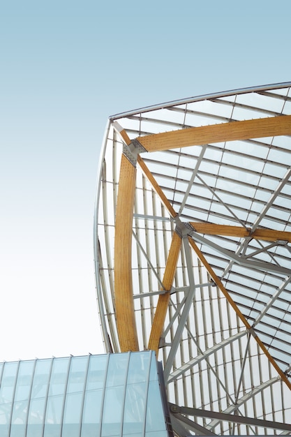 Vertical low angle shot of a metal and wooden building under the blue sky