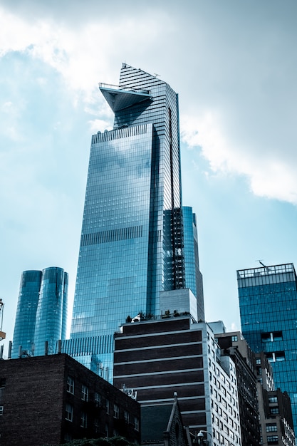 Free photo vertical low angle shot of modern glass business buildings touching the sky