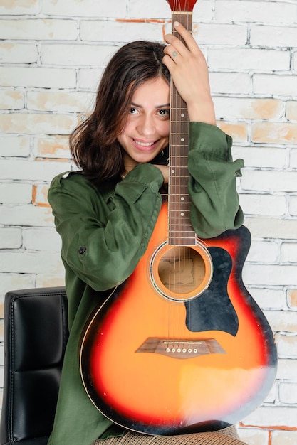 Vertical photo of sweet girl with guitar