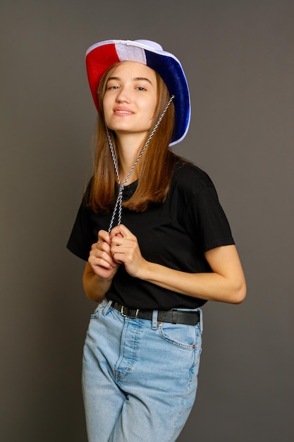 Free Photo vertical photo of young lady standing grey background and looking at the camera