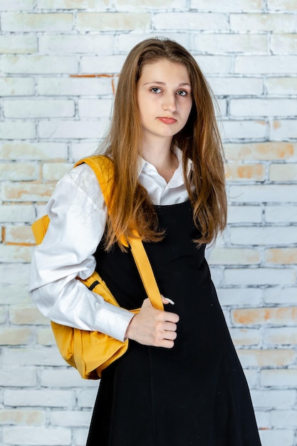 Vertical photo of young student looking at the camera High quality photo