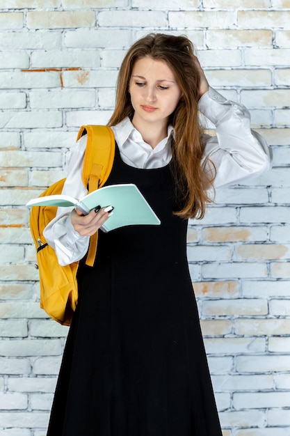 Free photo vertical photo of young student reading her notes high quality photo