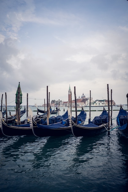 Free photo vertical picture of blue gondolas in a port at daytime