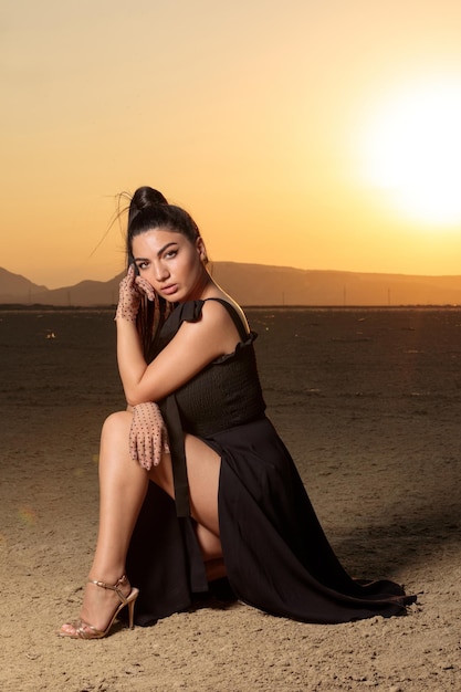 Free photo vertical portrait of young hot girl in desert at sunset high quality photo