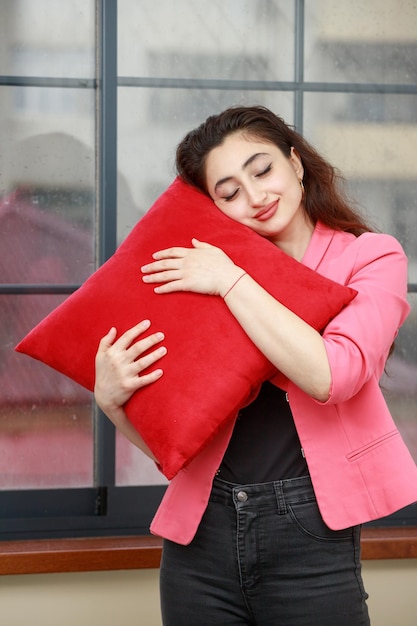 Vertical portrait of young lady hugged her pillow and closed her eyes High quality photo