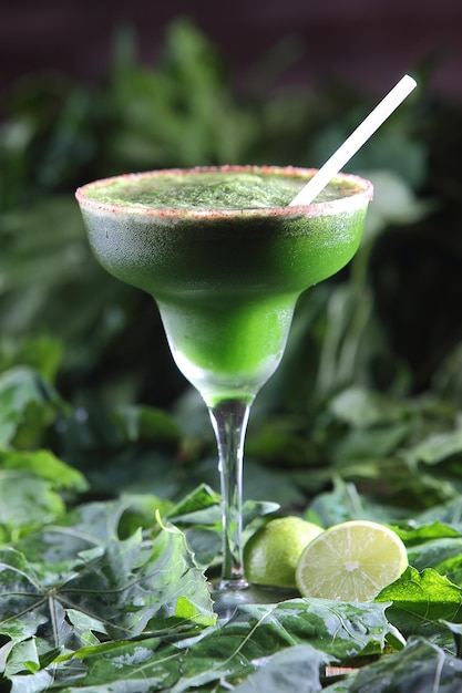 Vertical selective focus shot of Chaya or tree spinach cocktail with pepper