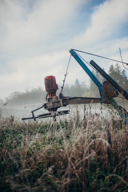 Free photo vertical shot of an agricultural harvester in the field