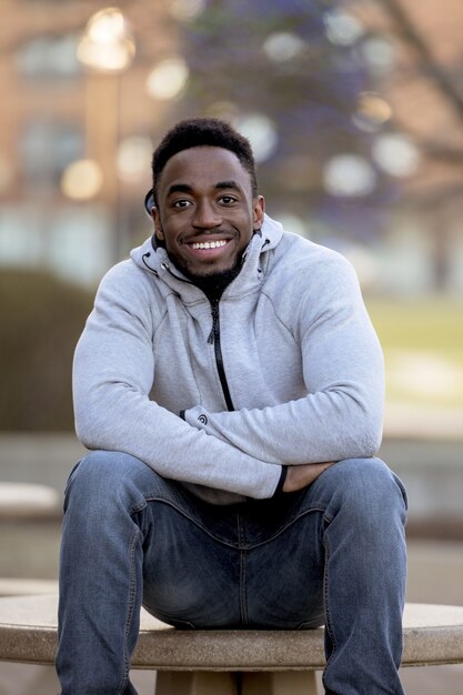 Vertical shot of an attractive African American male smiling in front of the camera