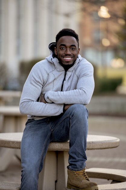 Vertical shot of an attractive African American male smiling in front of the camera