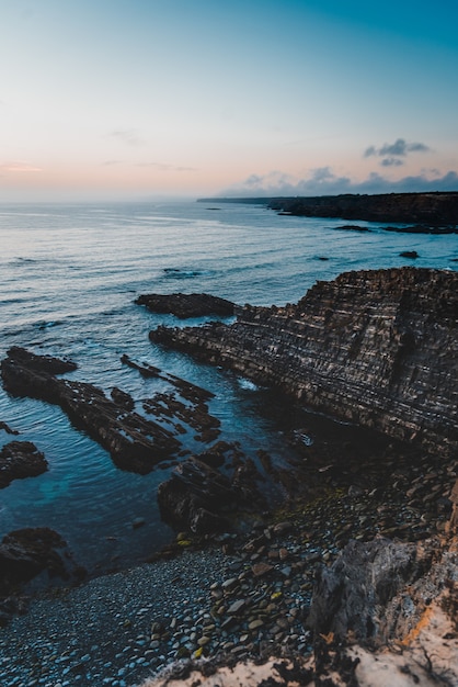 Free photo vertical shot of a beautiful sunset at the beach