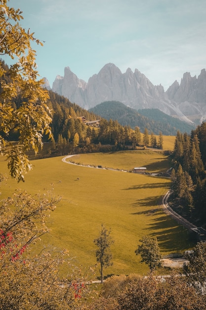 Free Photo vertical shot of a beautiful village in a hill surrounded by mountains