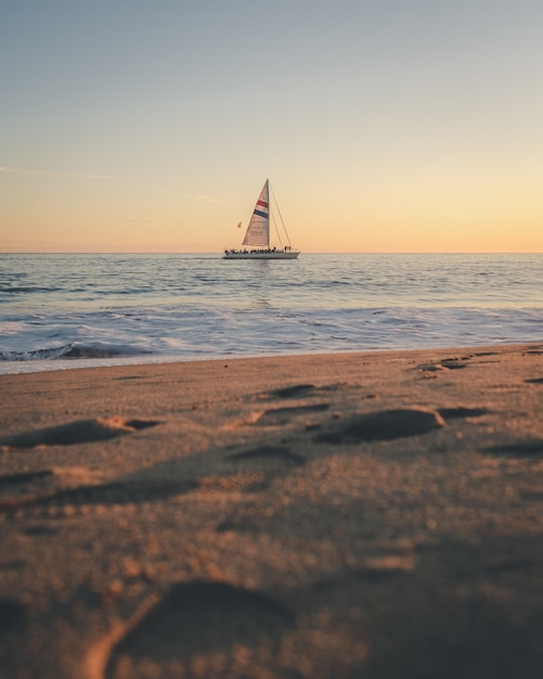 Free Photo vertical shot of a boat on the sea in the distance