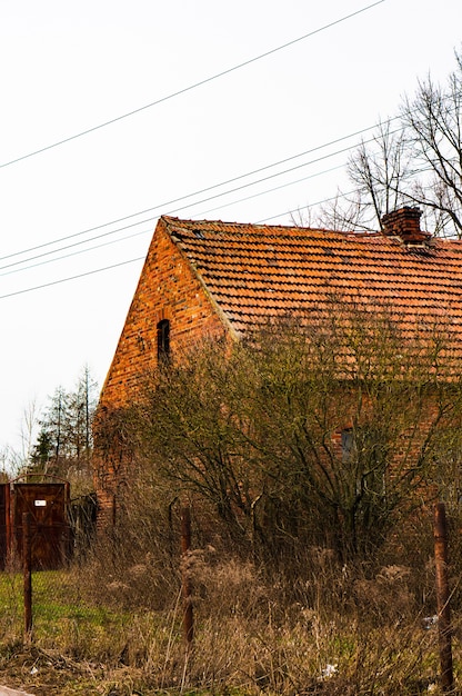 Vertical shot of the brick house and a garden next to it