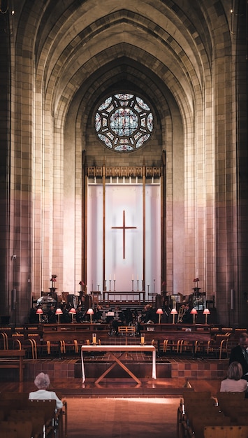 Free photo vertical shot of a church hall with a beautiful interior during a religious ceremony