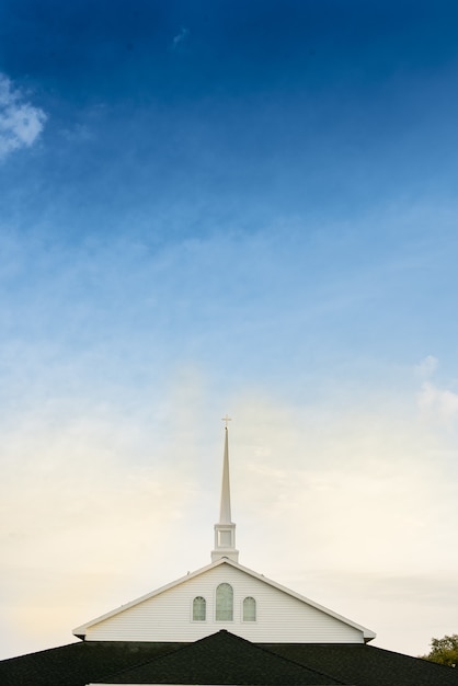 Free photo vertical shot of a church with a blue cloudy sky