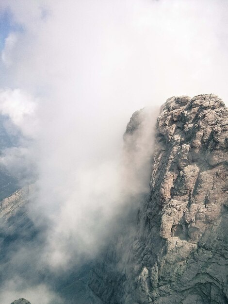 Vertical shot of the cliff on a foggy day - perfect for background