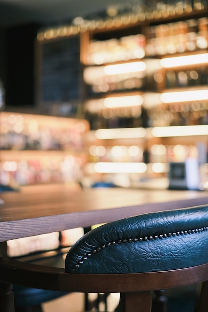 Vertical shot closeup on bar green chairs at the counter Closeup selective focus Bar view blur focus bar decoration idea or photo for interior