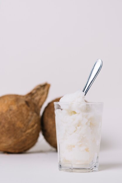 Vertical shot coconut oil with coconut nuts