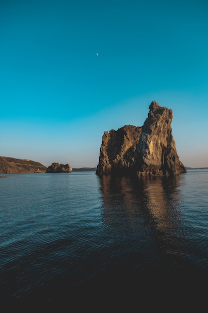 Free Photo vertical shot of a couple of big rocks in the sea