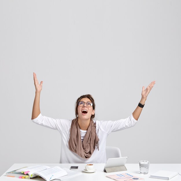 Vertical shot of depressed woman beggs for good luck at exam