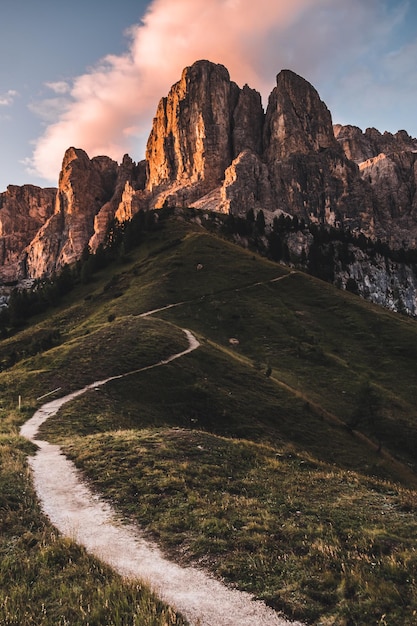 Vertical shot of the Dolomites surrounded by greenery in South Tyrol Italy