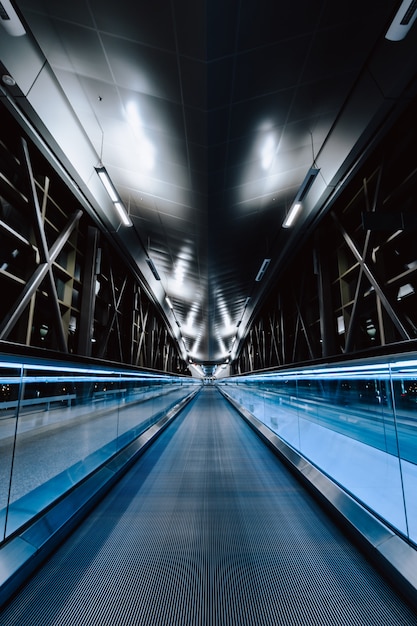 A vertical shot of an empty bridge at night time