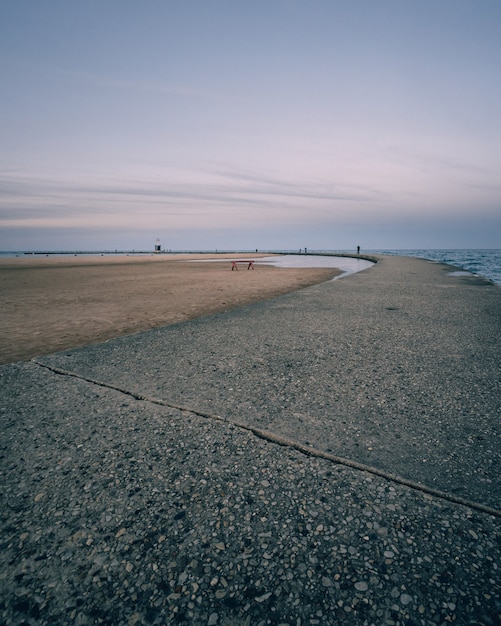 Vertical shot of an empty seashore and a clear blue sky