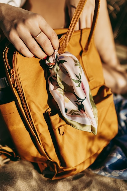 Vertical shot of a female holding a fashionable leather bg