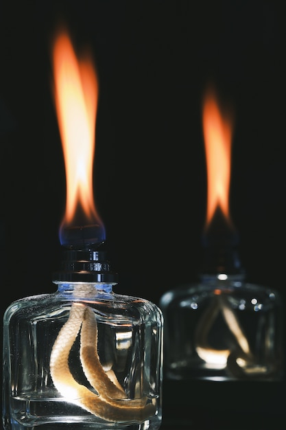 Vertical shot of the flames of scent diffusers in the dark