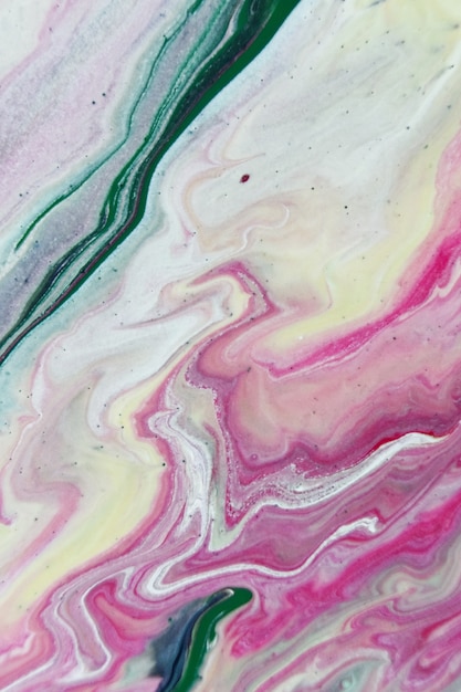 Free photo vertical shot of green pink and white abstract patterns with paints in the water