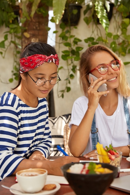 Vertical shot of interracial women meet for developing website