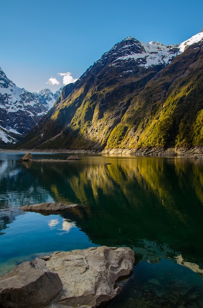 Vertical shot of the Lake Marian and mountains in New Zealand