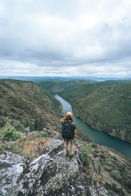 Free Photo vertical shot of a male tourist in sil canyon in spain