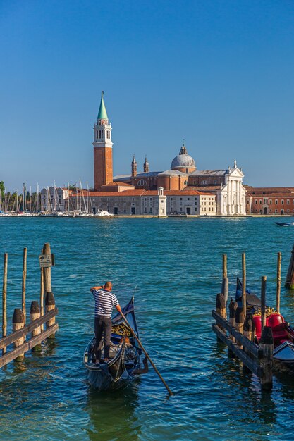 Vertical shot of a man on a boat and the St Mark's Square on the surface