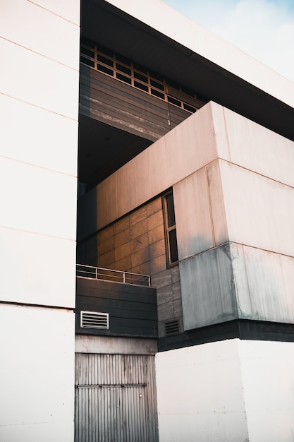 Vertical shot of a modern white building facade