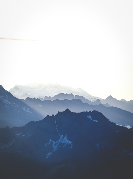 Free Photo vertical shot of mountains under a bright sky