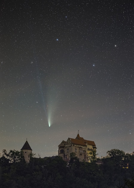 Free photo vertical shot of a neowise comet flying over the pernstejn castle in the czech republic