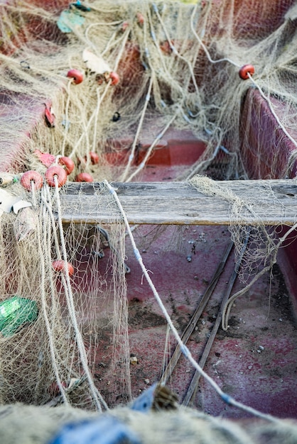 Vertical shot of an old boat covered with a fishing net