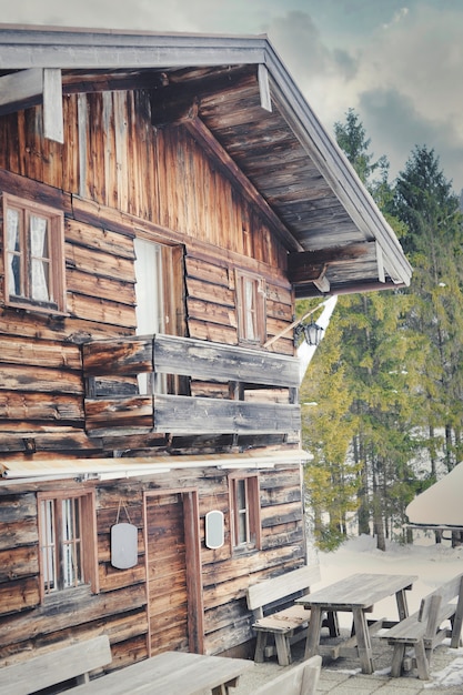 Free photo vertical shot of an old wooden house under the sunlight