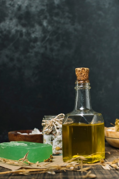 Free photo vertical shot olive oil with soap bar