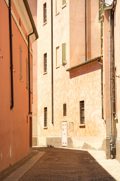 Vertical shot of a pathway in the middle of buildings at daytime