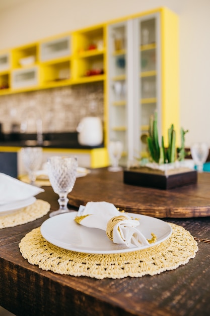 Vertical shot of a plate, glass, and a napkin on a table