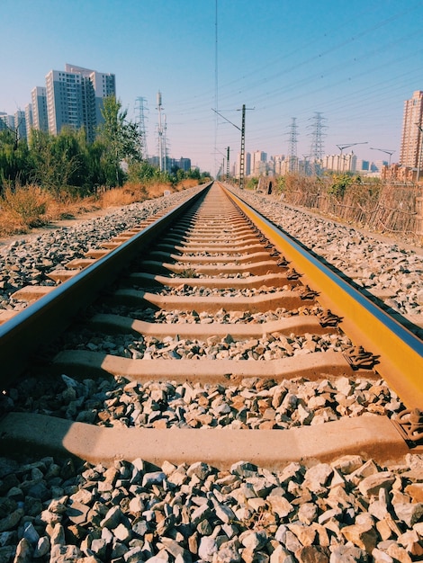 Vertical shot of railroad tracks with buildings