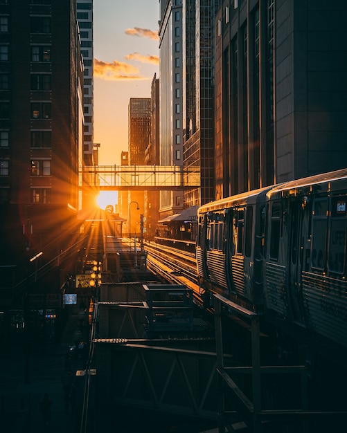 Vertical shot of a railway station with the train during the sunrise