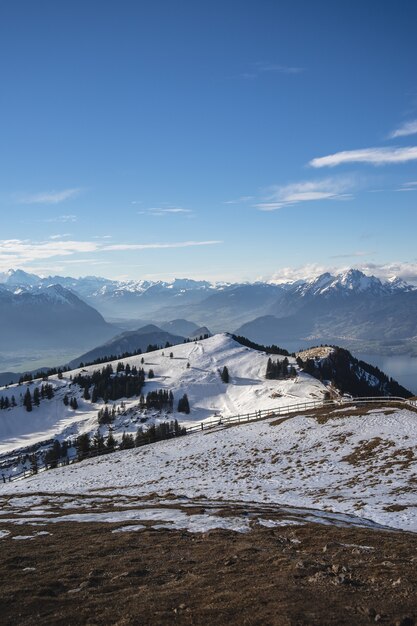 Vertical shot of Rigi Mountain  range in Switzerland under a blue sky