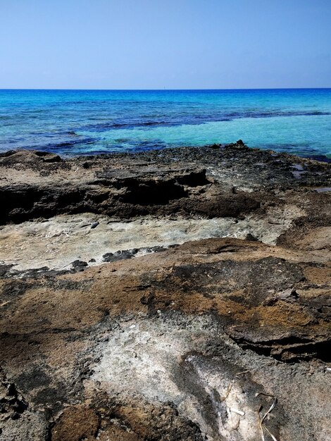 Vertical shot of the rocky beach in Formentera, Spain