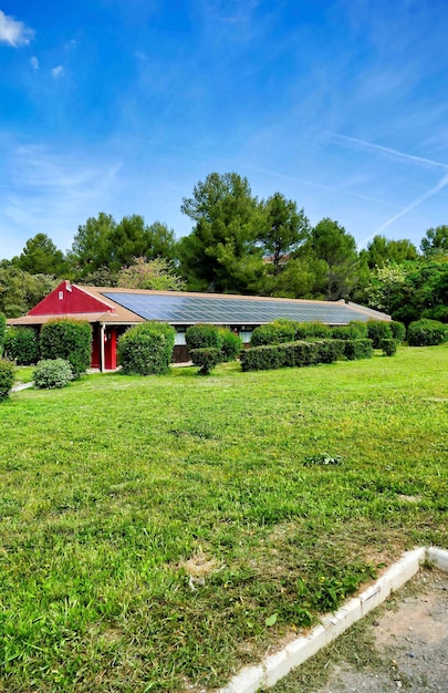 Vertical shot of a small house with solar panels in the green field in the Canary Islands