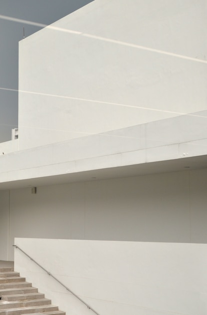 Vertical shot of a staircase next to a white wall