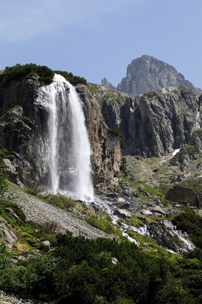 Vertical shot of a waterfall at the Susten pass located in Switzerland in winter during daylight